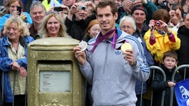 Andy Murray standing next to his gold painted post box during a walkabout in Dunblane