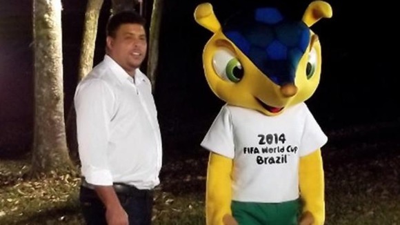 The mascot carries the colors of the Brazilian flag