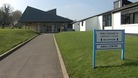 Exterior of King Edward VI Community College in Totnes with sign