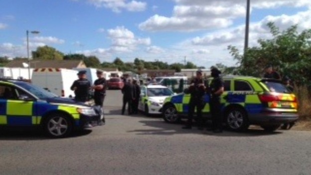 Police outside the Oxney Road travellers' site on the outskirts of Peterborough