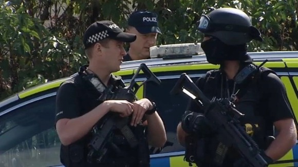 Police outside the Oxney Road travellers' site on the outskirts of Peterborough.