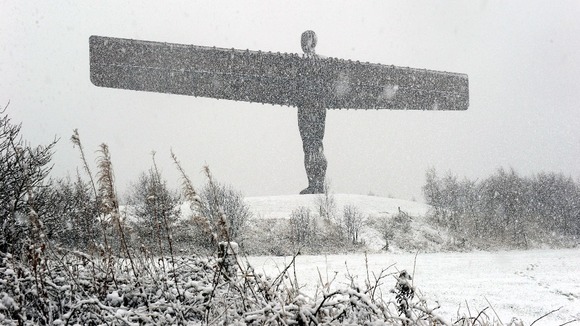 The Angel of the North statue is covered in heavy snow