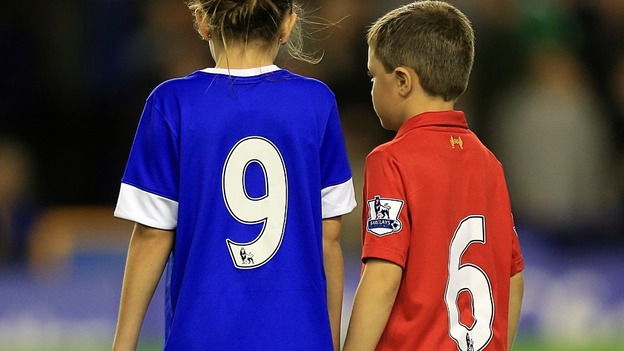 A young Everton and Liverpool fan pay tribute to the 96 people who died in the Hillsborough tragedy