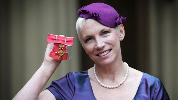 Musician Annie Lennox poses with her OBE which she received from Queen Elizabeth II at Buckingham Palace in London.