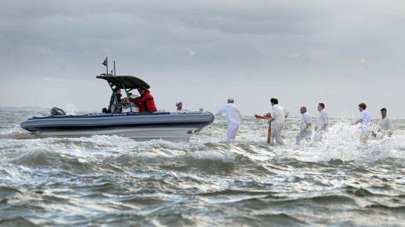 Cricketers and a boat