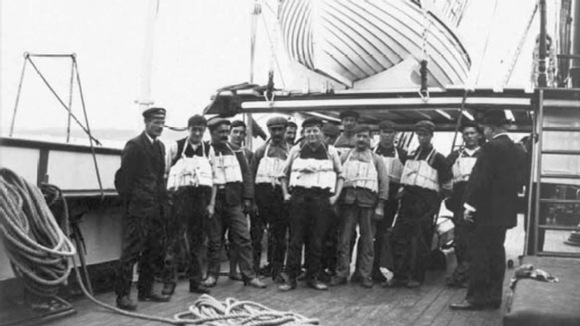 Crewmen demonstrating life vests