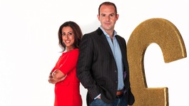 Saira Khan and Martin Lewis standing next to a huge Gold pound sign, an oversize pound coin and a knee high credit card.