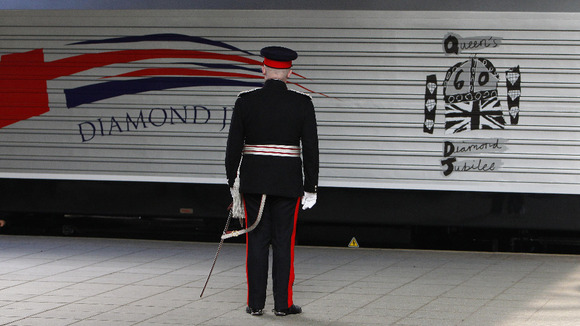 The train carrying Queen Elizabeth II and the Duke of Edinburgh arrives at Victoria Station in Manchester with a new Diamond Jubilee livery