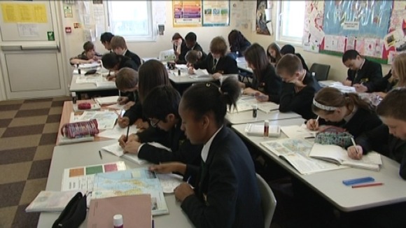 Pupils learning in the cramped mobile classrooms