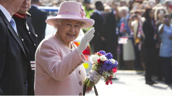 The Queen waves to crowds in Manchester