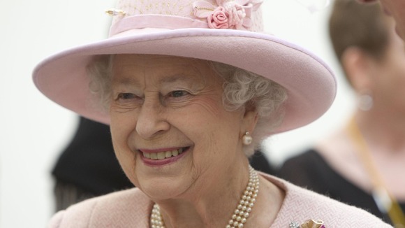 Queen smiles at crowds in Manchester