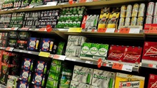 Supermarket shelves stacked with beer