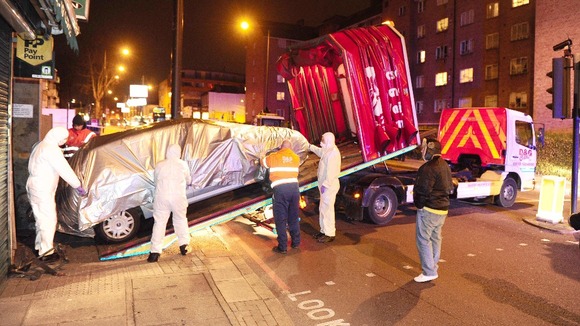 A Fiat Stilo, where Kirsty Treloar, 20, was found stabbed to death, is removed from Ryder Mews in Hackney, east London.