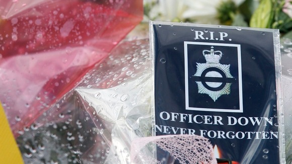 A card that reads: "RIP OFFICER DOWN NEVER FORGOTTEN"