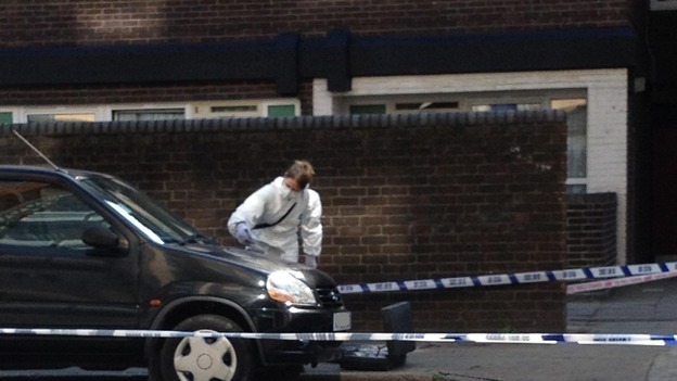 Forensics examine the scene in the Canary Wharf district of London where a Russian banker was killed on Tuesday.