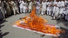 Supporters of Islami Jamiat Talaba burn an American flag as they shout anti-American slogans during a protest in Lahore.