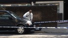 Forensic teams examine the crime scene on Byng Street, east London