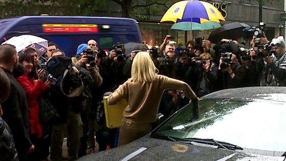 Britt Ekland shows photographers the golden briefcase carrying the Bond 50 Blu-ray Collection