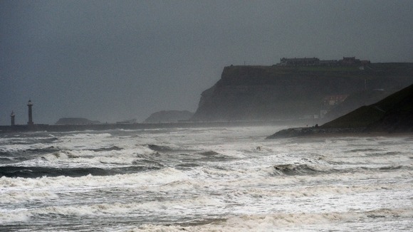 White capped waves at Whitby today as torrential rain and gale force winds sweep across much of the UK.