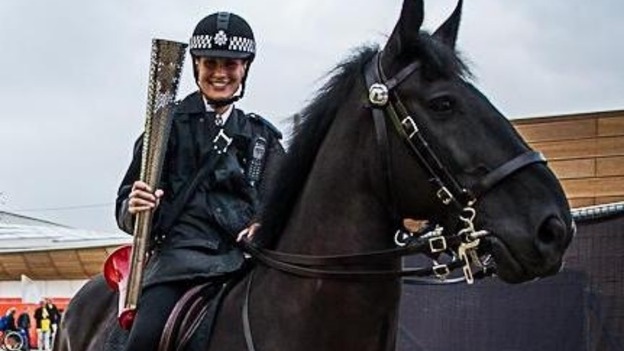 Lorcan and PC Claire Twigg carrying an Olympic torch 