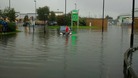 A driver wades through water at a retail park in Wigan