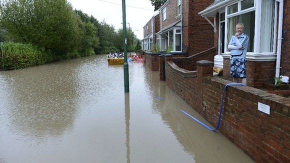 Residents look on in Chester-Le-Street as water levels rise.