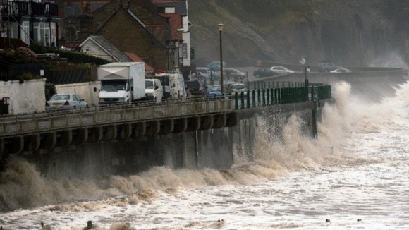 Gale force winds drive waves over the coastal road at Sandsend, North Yorkshire yesterday.