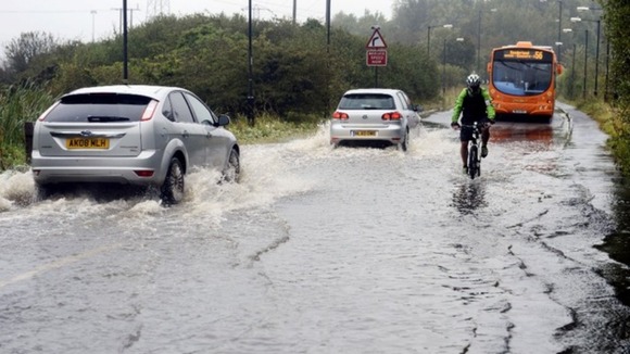 Motorists make their way through flood water in Washington, Tyne and Wear.