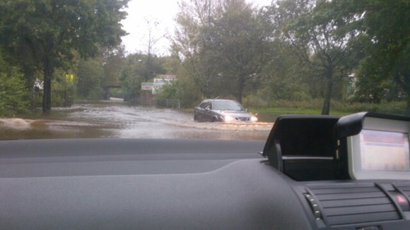 Cars struggle through flooding in St Helens