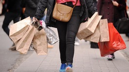 A shopper carrying shopping bags on Oxford Street in London.