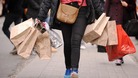 A shopper carrying shopping bags on Oxford Street in London.