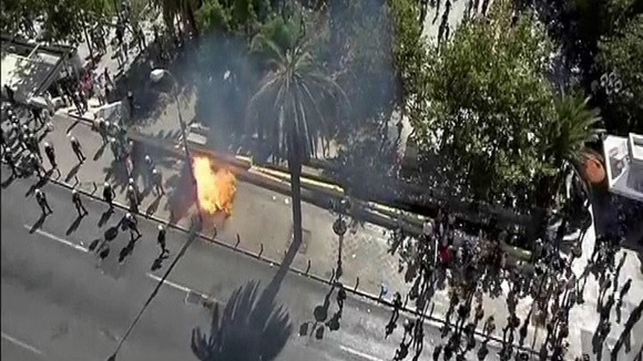 Riot police dodge petrol bombs from protesters in central Athens.