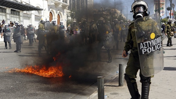 A police officer confronts the protesters.