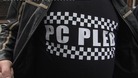Police officers gather outside Andrew Mitchell's constituency office