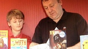 father and son opening cards
