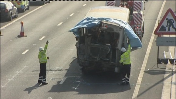 Recovery workers covering up the bus involved in this morning's crash