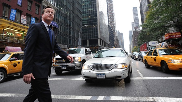Prime Minister David Cameron walks through the streets of New York after addressing the UN General Assembly in New York yesterday.