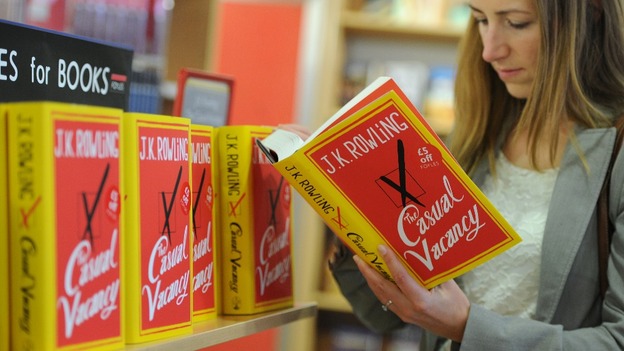 A customer reads JK Rowling's new book.