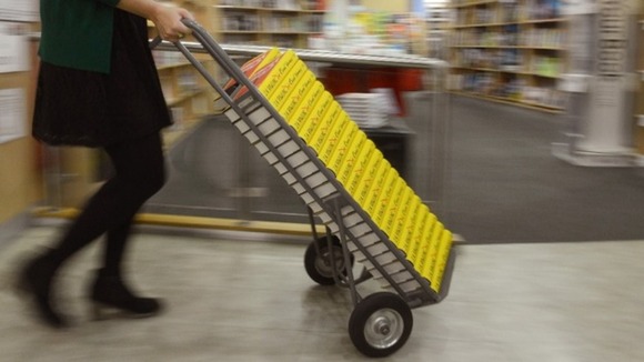 Scores of books are readied for the shelves.
