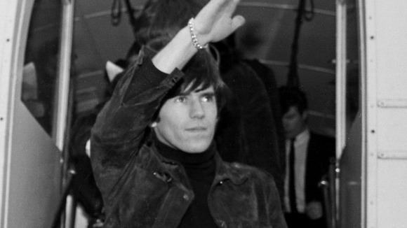 Brian Jones of The Rolling Stones waves to fans at Dublin Airport