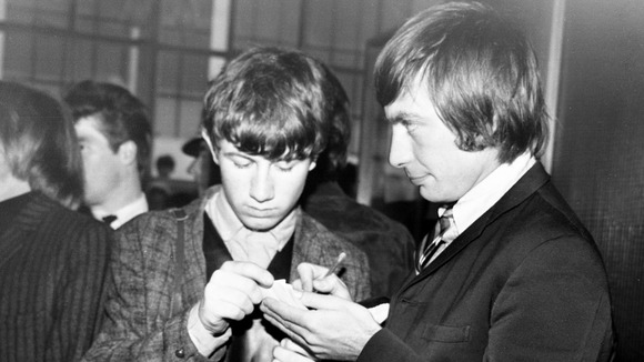 The Rolling Stones's Charlie Watts signing an autograph for a young fan, at Dublin Airport