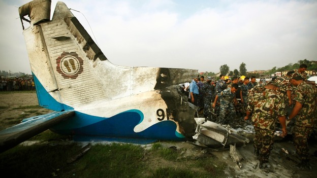 Rescue team members work at the site where a Dornier aircraft crashed in Kathmandu, Nepal.