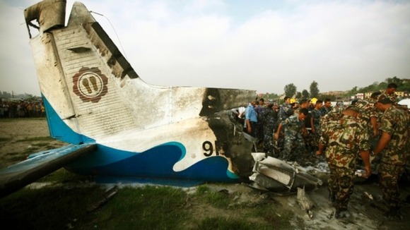Rescue team members work at the site where a Dornier aircraft crashed in Kathmandu, Nepal.