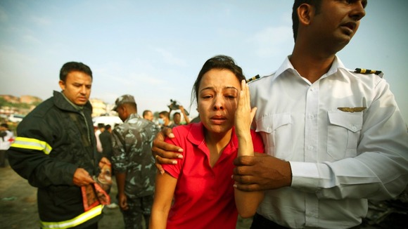 A woman cries at the crash site in Kathmandu.