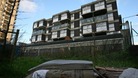 A mattress lies next to similar ones on a patch of wasteland on the corner of Commercial Street and Pomell Street in Tower Hamlets.