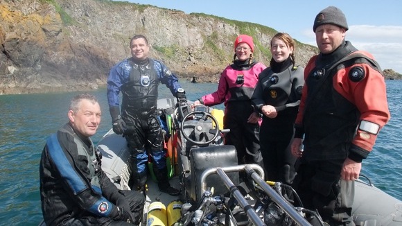 Darren Kelly (pictured in a red suit on the far right) was among 7 British tourists killed in the plane crash