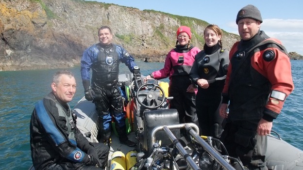 Darren Kelly (pictured in a red suit on the far right) was among 7 British tourists killed in the plane crash