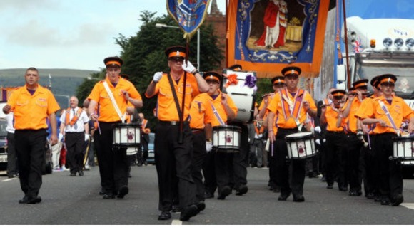 Orange Order bandsmen on the march in Belfast, in July