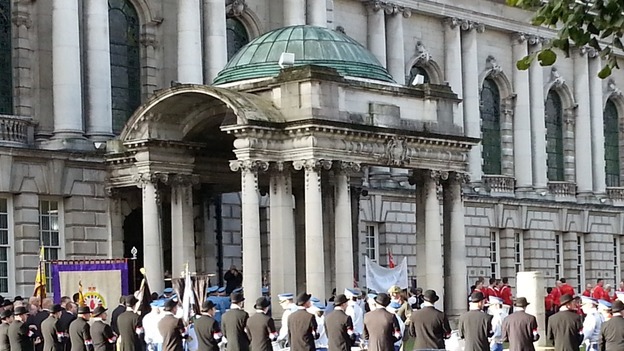 The Belfast City hall surrounded by Orange Order members