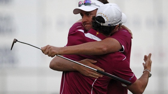 Ian Poulter hugs teammate Rory McIlroy